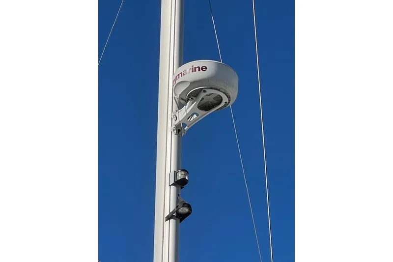 Sailboat mast with radar equipment on a 2016 Catalina 385 against clear blue sky.