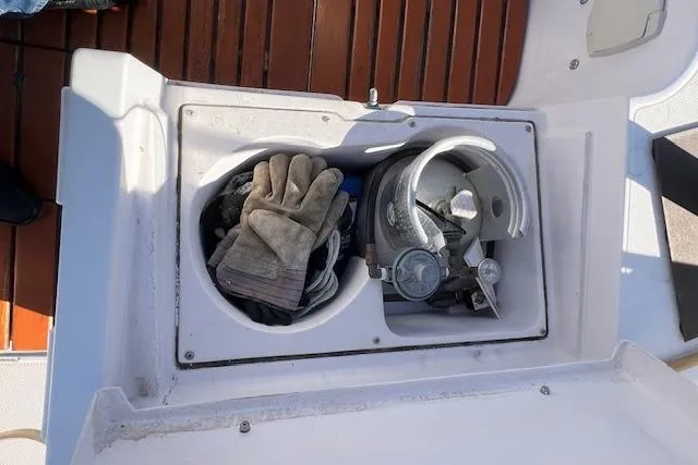 Storage compartment on 2016 Catalina 385 sailboat with gloves and equipment.