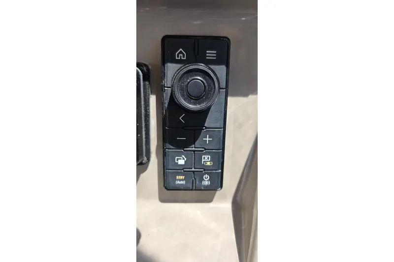 Control panel of a 2001 Cruisers Yachts 340 Express, featuring navigation and function buttons.