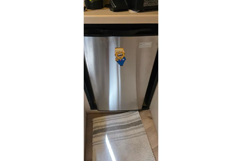 Stainless steel fridge with cartoon magnet inside 2001 Cruisers Yachts 340 Express.