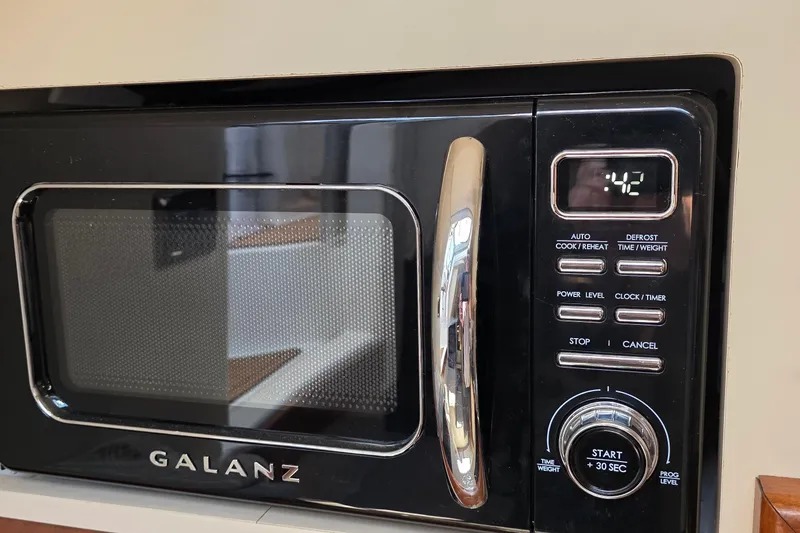 Black Galanz microwave with digital display showing 42 seconds.