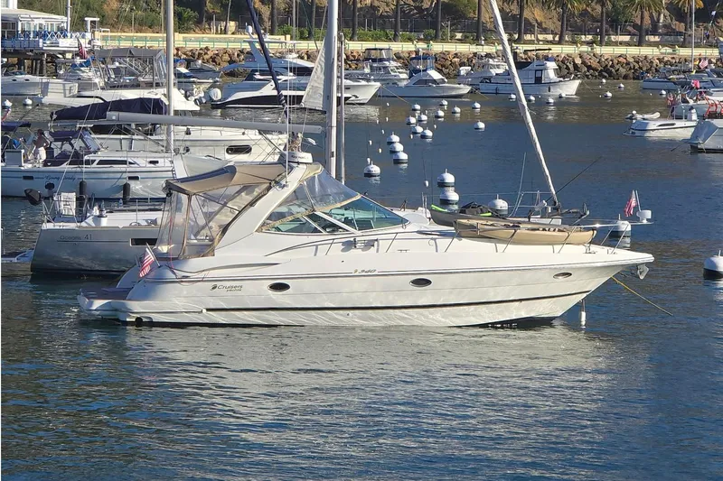 2001 Cruisers Yachts 340 Express moored in a busy marina with other boats.