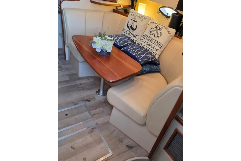 Interior of 2001 Cruisers Yachts 340 Express with cozy seating and decorative pillows.