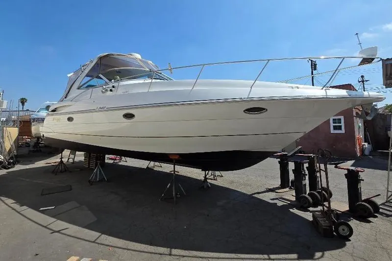 2001 Cruisers Yachts 340 Express on stands, outdoor setting, clear sky.