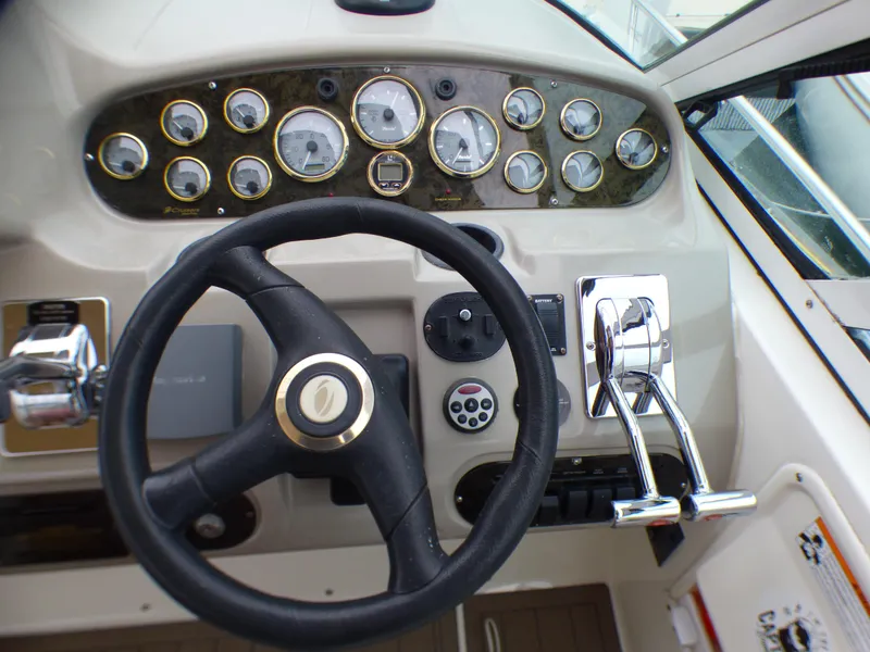 2001 Cruisers Yachts 340 Express helm with gauges and steering wheel.