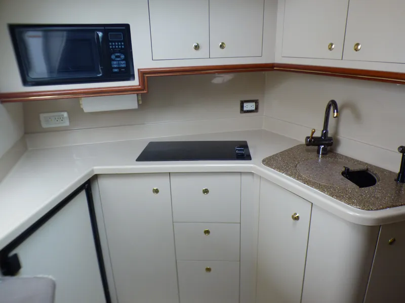 Cruisers Yachts 340 Express 2001 kitchen with microwave and sink.