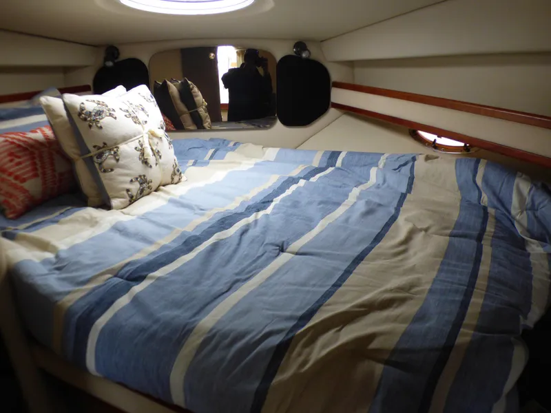 Cruisers Yachts 340 Express 2001 cabin with striped bedding.