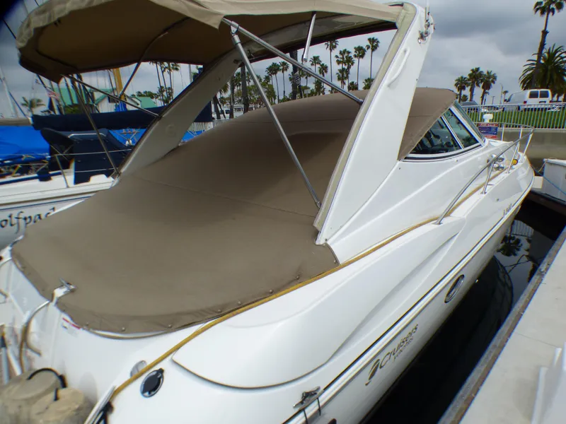 2001 Cruisers Yachts 340 Express with cover in marina.