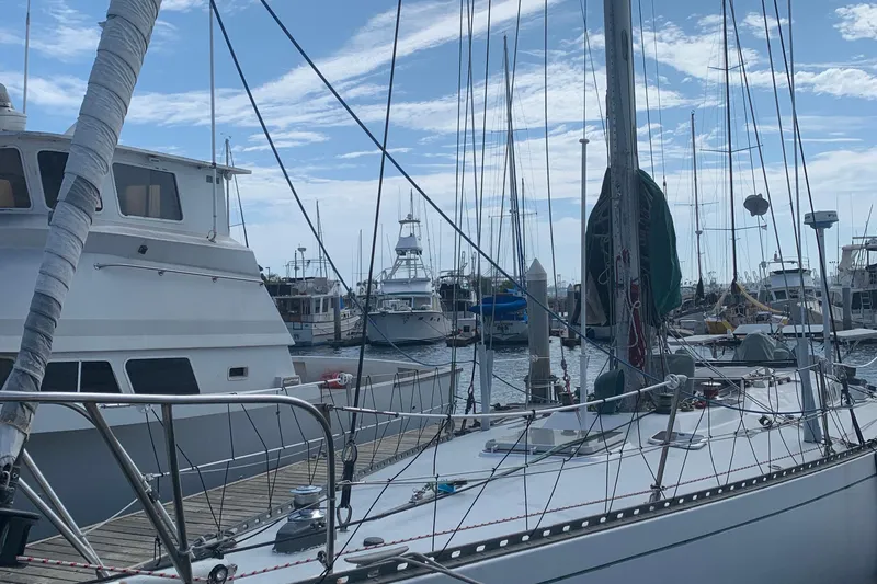 Sailboats docked at a marina, featuring a 1972 Tartan 41 under a clear blue sky.