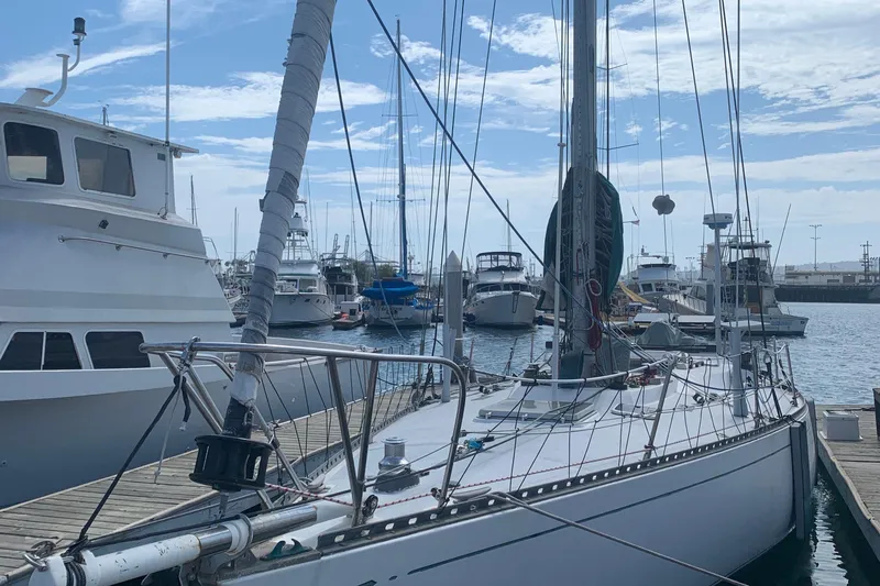 Sailboat docked at marina, Tartan 41 model, 1972, surrounded by other boats.