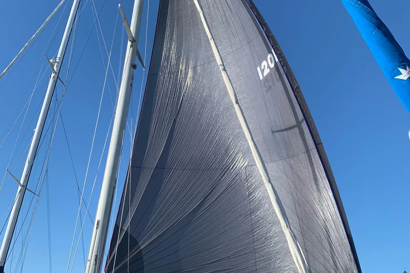 Sailboat with tall mast and sails against clear blue sky, Tartan 41, 1972 model.