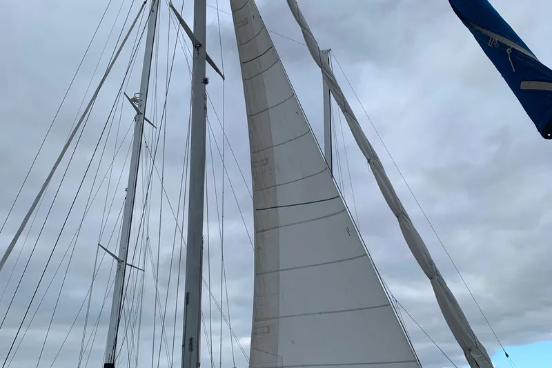 Sailboat mast and sails of a 1972 Tartan 41 under cloudy skies.