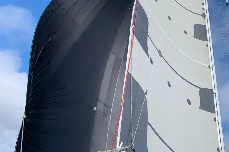 Sailing yacht Tartan 41, 1972 model, with large sails against a blue sky.