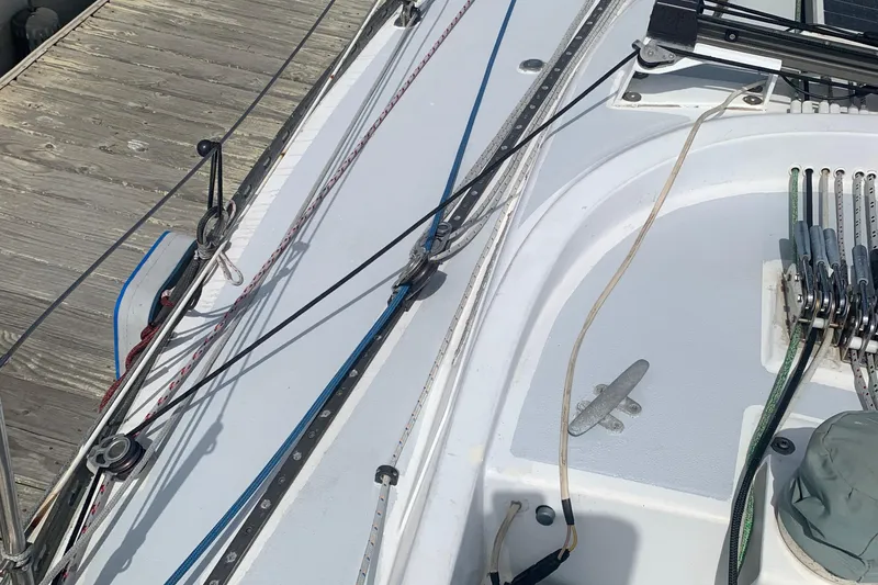 Deck of a 1972 Tartan 41 sailboat with rigging and dock.