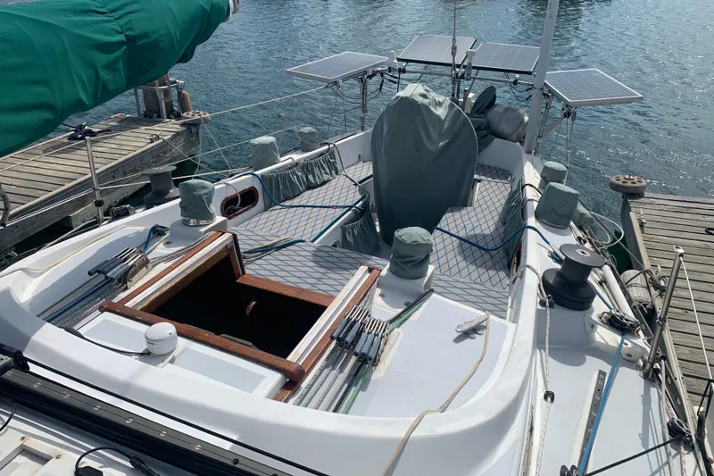 1972 Tartan 41 sailboat docked, featuring solar panels and covered equipment on deck.