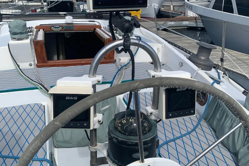 Cockpit of a 1972 Tartan 41 sailboat with navigation instruments and steering wheel.