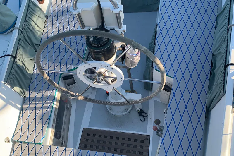Cockpit of a 1972 Tartan 41 sailboat with a large steering wheel and compass.