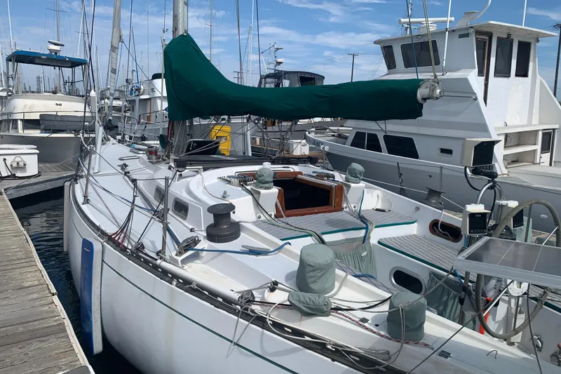 1972 Tartan 41 sailboat docked at marina, featuring green sail cover.