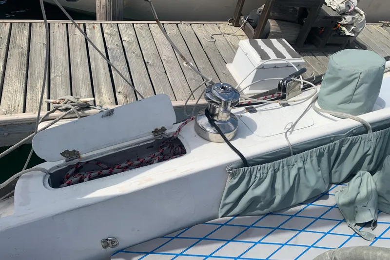 1972 Tartan 41 sailboat deck with winch, ropes, and dock in view.