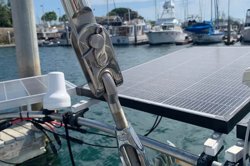 Close-up of a Tartan 41 sailboat's rigging with solar panels in a marina, 1972 model.