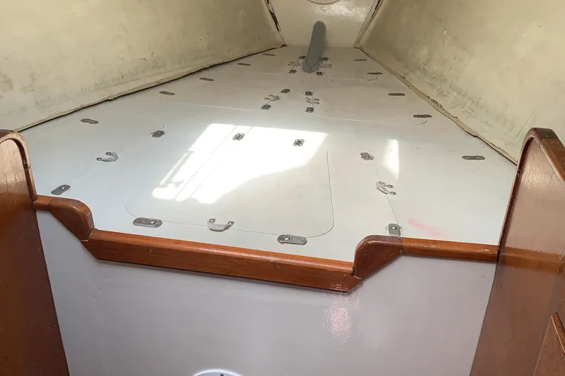 Interior of a 1972 Tartan 41 sailboat with wooden trim and storage compartments.