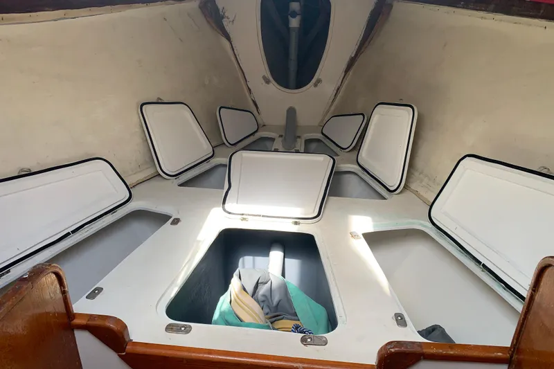 Interior of a 1972 Tartan 41 sailboat with open storage compartments.