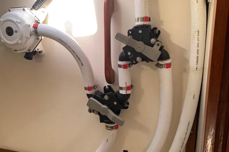 Plumbing system in a 1972 Tartan 41 sailboat, featuring hoses and valves.