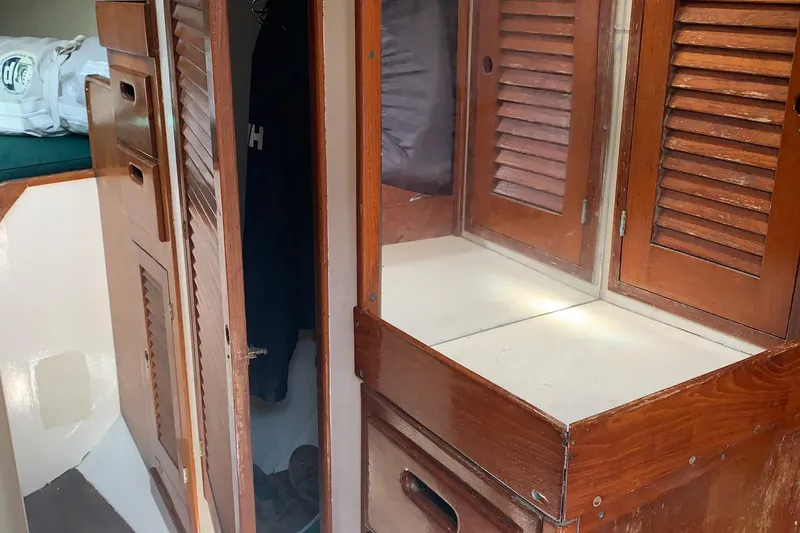 Interior of a 1972 Tartan 41 sailboat with wooden cabinetry and storage.