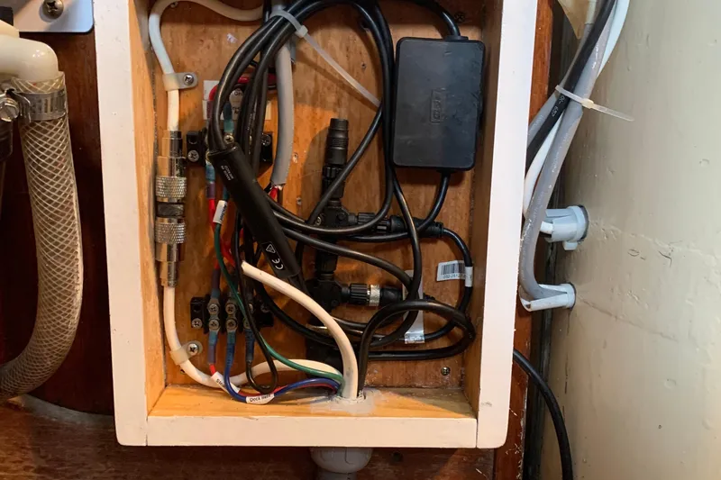 Electrical wiring inside a Tartan 41 sailboat, 1972 model, showcasing cables and connectors.