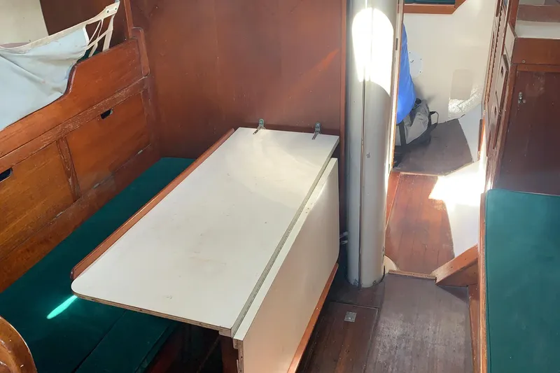 Interior of a 1972 Tartan 41 sailboat with wooden furnishings and a foldable table.