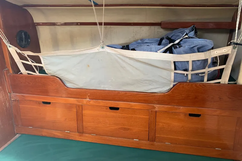 Interior of a 1972 Tartan 41 sailboat with wooden storage and netting.