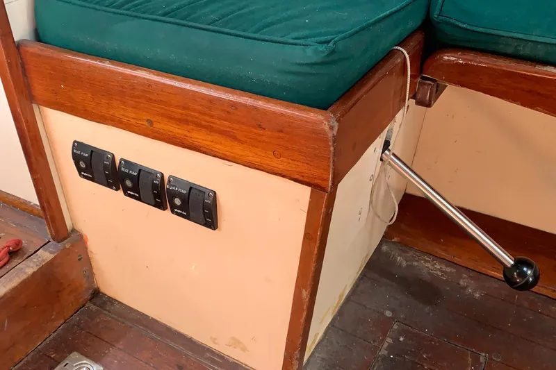 Interior of a 1972 Tartan 41 sailboat with control switches and wooden seating.