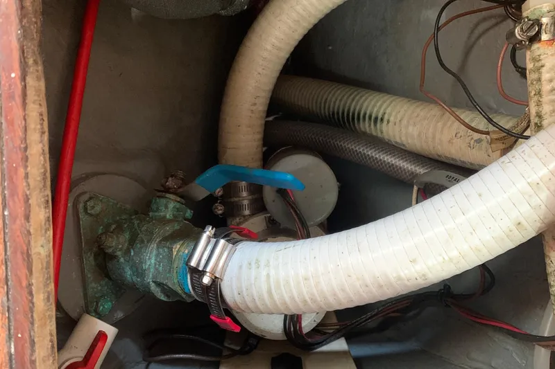 Engine compartment of a 1972 Tartan 41 sailboat with hoses and wiring.