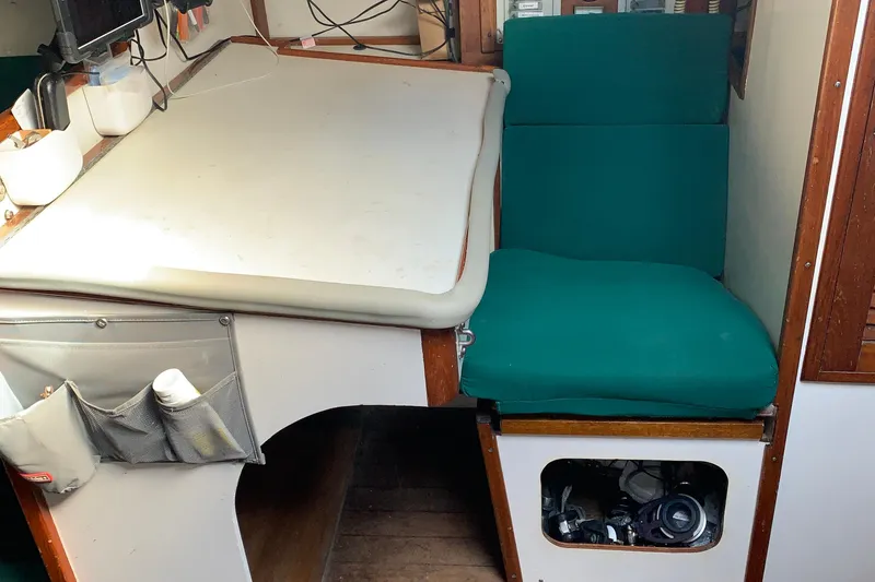 1972 Tartan 41 yacht interior with green cushions and navigation station.