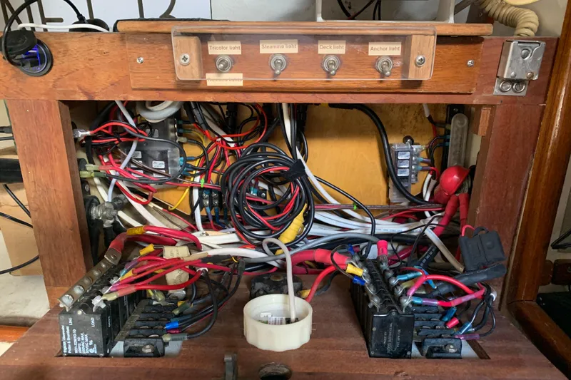 Electrical panel of a 1972 Tartan 41 sailboat with wiring and switches.