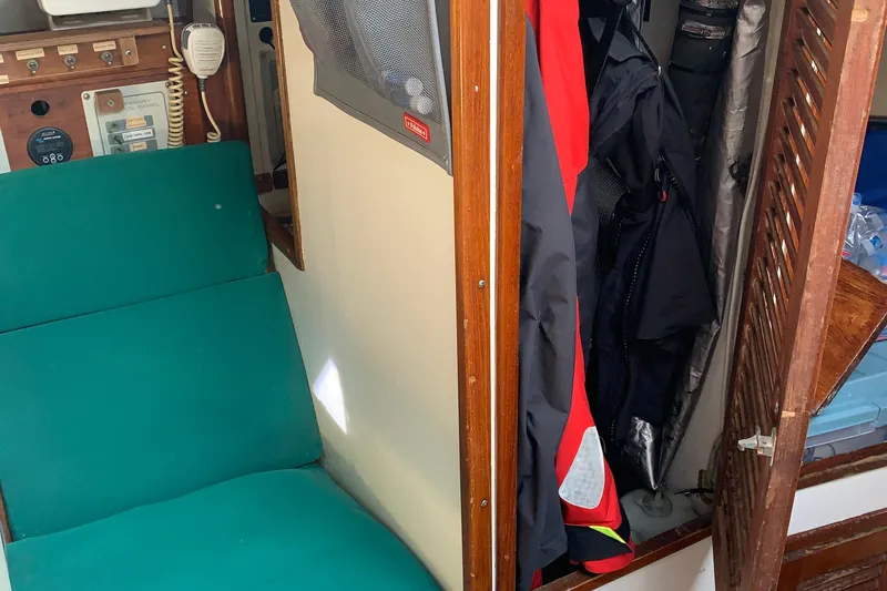 Interior of a 1972 Tartan 41 sailboat with green seating and storage area.