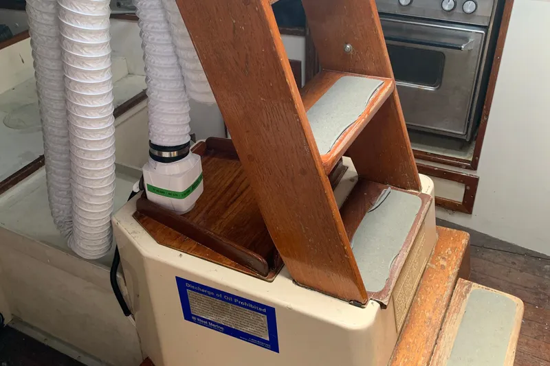 Interior of a 1972 Tartan 41 sailboat with wooden steps and ventilation ducts.