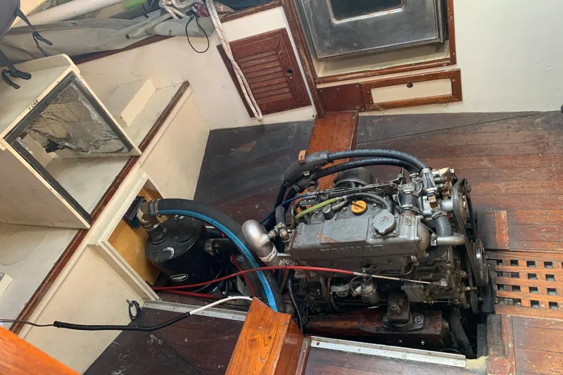 Engine compartment of a 1972 Tartan 41 sailboat, showcasing mechanical components and wooden interior.