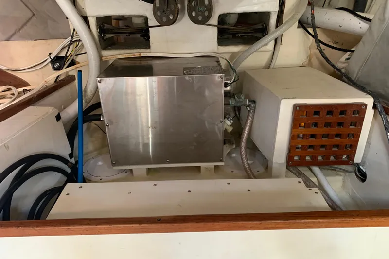 Engine compartment of a 1972 Tartan 41 sailboat, featuring mechanical components and wiring.