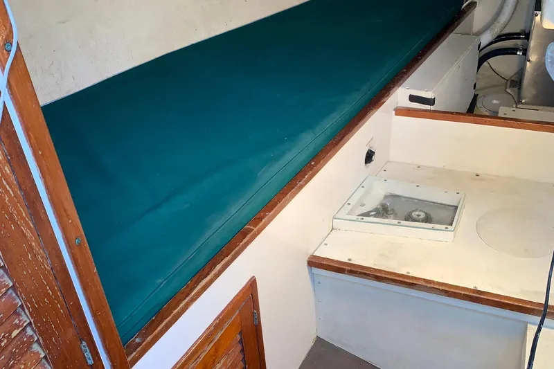 Interior of a 1972 Tartan 41 sailboat with teal cushioned seating.