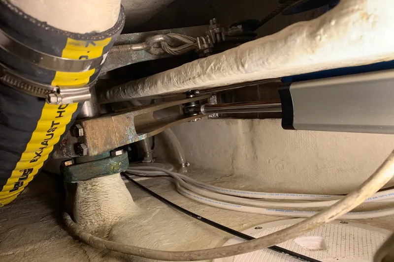 Engine compartment of a 1972 Tartan 41 sailboat, showing exhaust hose and mechanical components.
