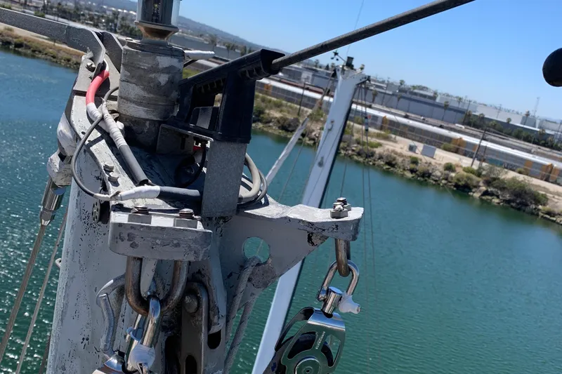 Close-up of a 1972 Tartan 41 sailboat mast with rigging over water.