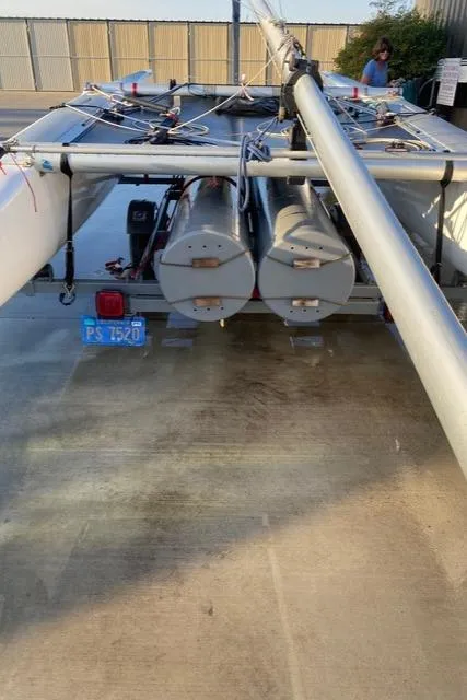 1989 Nacra 5.8 catamaran on trailer, rear view, with visible license plate.