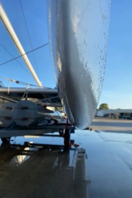 Close-up of a 1989 Nacra 5.8 catamaran hull on a sunny day.