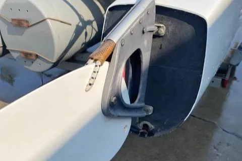 Close-up of a 1989 Nacra 5.8 sailboat rudder and tiller mechanism.
