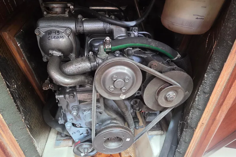 Engine compartment of a 1995 Hunter 336 sailboat, showing belts and hoses.