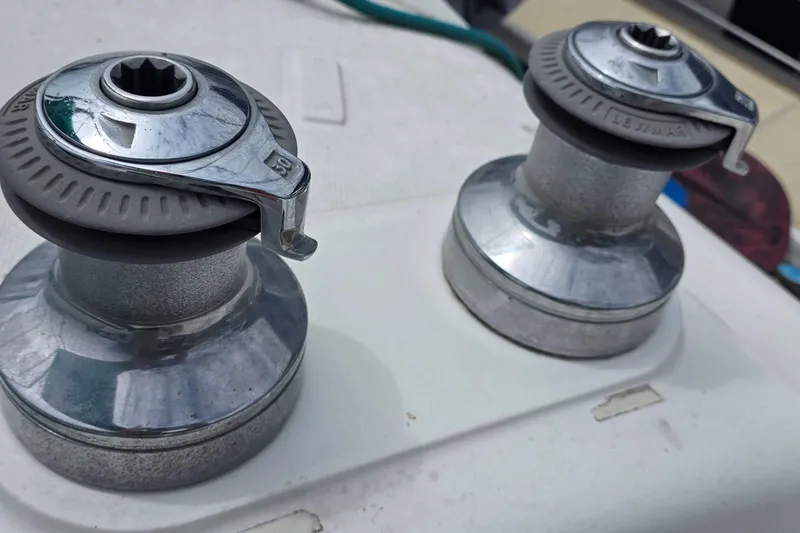 Close-up of two chrome winches on a 1995 Hunter 336 sailboat deck.