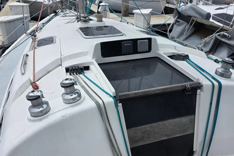 Sailboat deck of a 1995 Hunter 336, featuring winches and rigging lines.