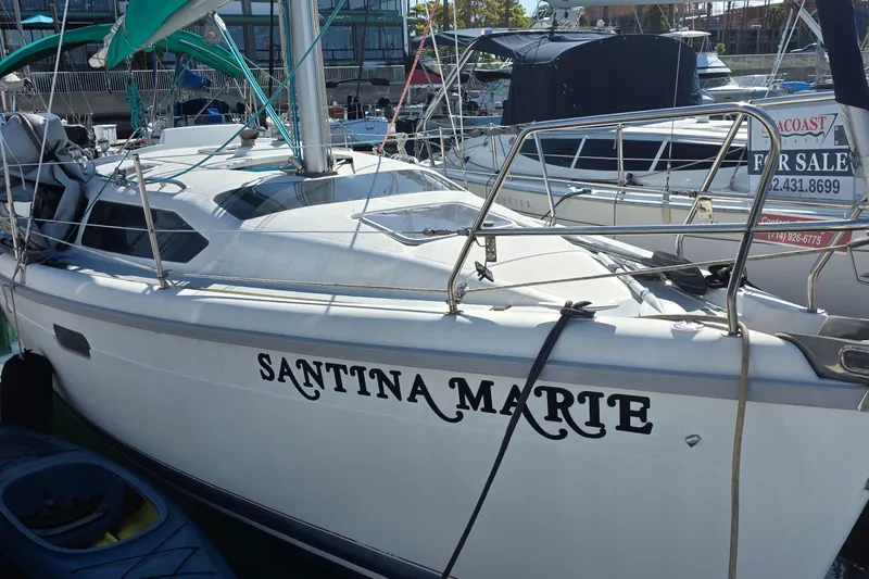 Sailboat "Santina Marte" docked, Hunter 336 model, 1995, with a "For Sale" sign visible.