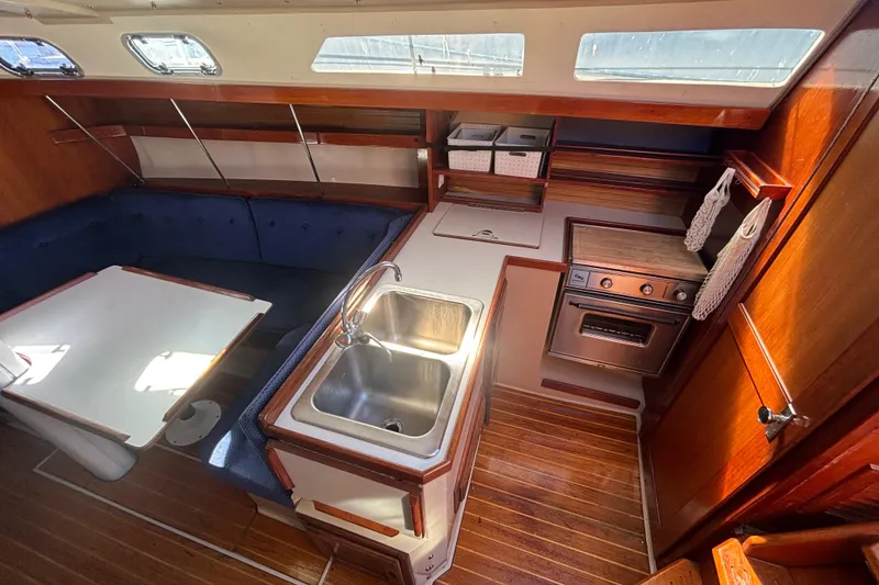 1988 Catalina 34 yacht interior with kitchen, dining area, and wooden finishes.